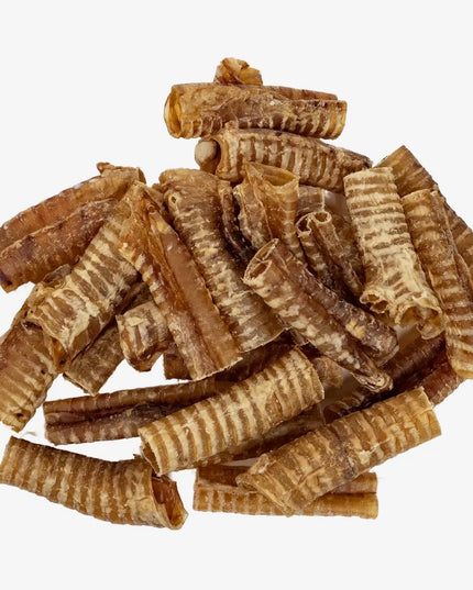 Stack of brown rolled snacks on a white background